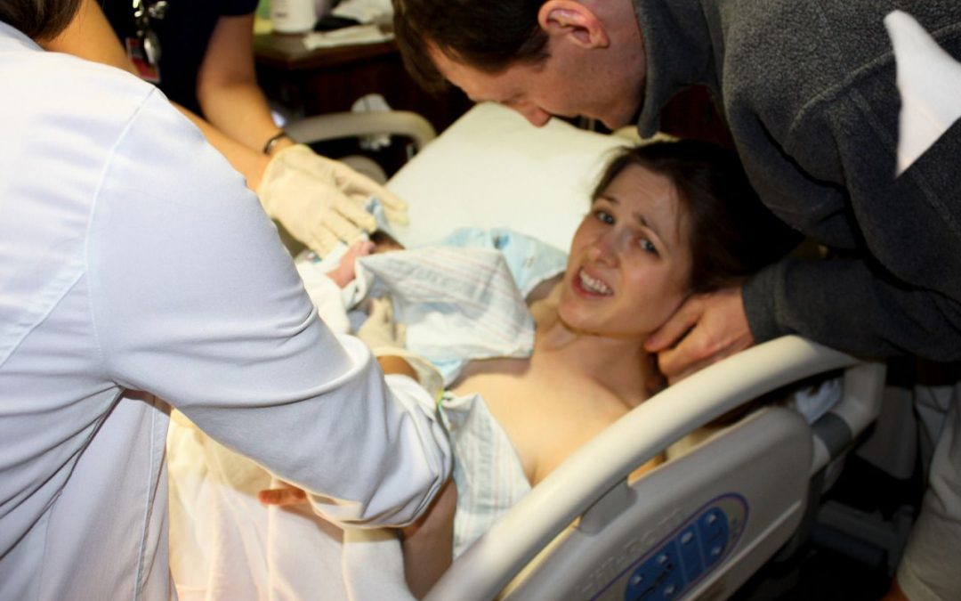 New born baby - girl with remainder of umbilical cord after successful  childbirth. Real birthing and new